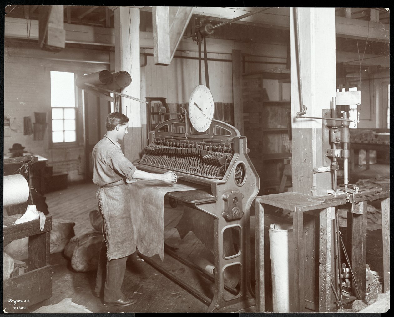 ニューヨークレザーベルト社、1906年にレザーを扱う男性の内部ビュー（シルバーゼラチンプリント） 作： バイロンカンパニー