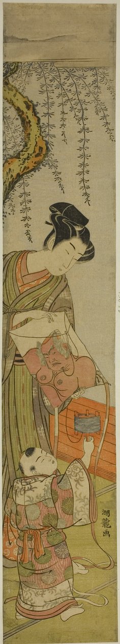 若い男が子供のために凧を持っている 作： Is田流彩