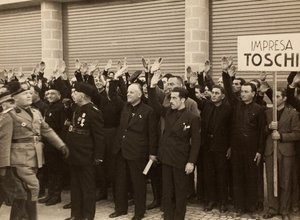 1936年10月24日、ボローニャの王立空港 "Fausto Fish "の建物の落成式で、ベニート・ムッソリーニ総統に敬礼するマウロ・トスキ・フウリッセ社の建設労働者たち（モノクロ写真）。