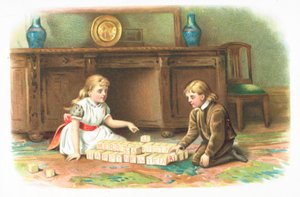 床、クリスマスカードのビルディングブロックで遊んでいる子供たち