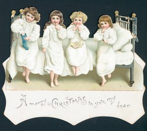 クリスマスカード、ストッキングが付いているベッドの上の子供