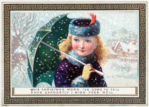 雪の中、クリスマスカードの傘を保持している女の子