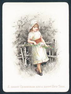 花、クリスマスカードのスプレーを保持しているフェンスに寄りかかって女の子。