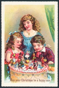 クリスマスケーキ、クリスマスカードを眺める女性と子供