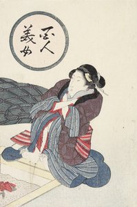 囲炉裏で足を温める女性
