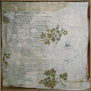 ヴェルレーヌが詩「Les Amies」と「Le Printemps」を書いたテーブルクロスに、カザルスによるヴェルレーヌの肖像画（布にペンとインク） 作： Paul Verlaine