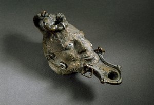 ローマ美術：顔の形をしたブロンズ製オイルランプ。紀元1〜2世紀スペイン アムプリアス美術館（アムプリアス 作： Roman