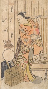 鏡台のそばに立つ女性役の俳優。 1735年。 作： Torii Kiyotada