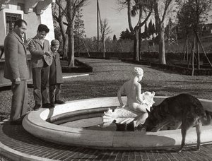 噴水の近くで2人の子供と犬を連れたジーノ・バルタリ 作： Unknown photographer