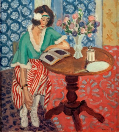 テーブルで読書する女性（緑と赤のストライプのドレス 作： Henri Matisse
