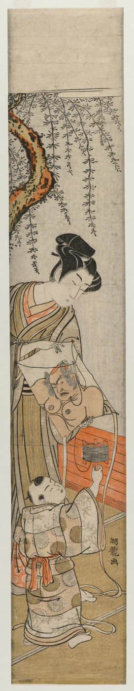 1770年代初頭から中頃の凧を持った若い男と子。 作： Isoda Koryusai