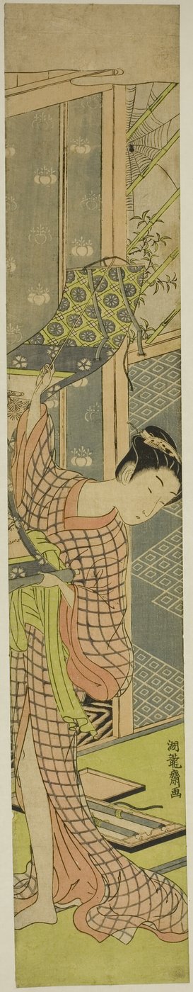 絵を掛ける若い女性 作： Isoda Koryusai