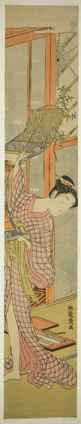 絵を掛ける若い女性 作： Isoda Koryusai