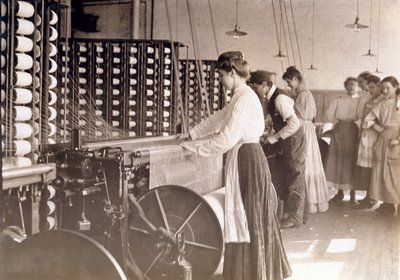 1908年、サウスカロライナ州の綿工場の紡績機で働く若い女性 作： Lewis Wickes Hine