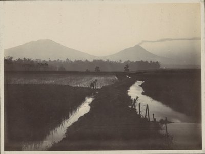 噴火する火山のふもとで土地を耕す男 作： Onnes Kurkdjian