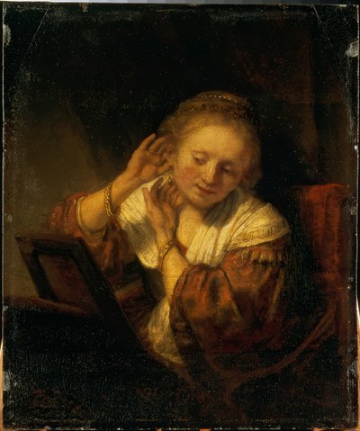 イヤリングで自分を飾る若い女性 作： Rembrandt van Rijn