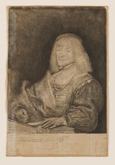 机に向かう男性。首には十字架とチェーンを身につけている。 作： Rembrandt van Rijn