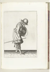 盾とスパイクを使った演習: 兵士は右足の隣の地面にスパイクを置きます (No. 16), 1618 Nassausche Wapen-Handelinge、van Schilt、Spies、Rappier ende Targe : 人物によって描かれ、[の] 新しい秩序に従ってポーズをとった (...) M