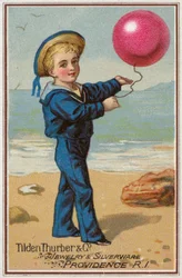 赤い風船を持った船乗りの少年