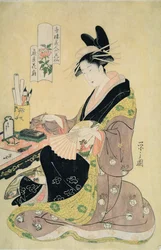 自分の机で絵を描く女性（カラー木版画）