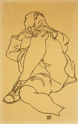 頭を組んだ足で休んでいる若い男。 1918年に頭を下にして左脚を折りたたんでいる横になった少年