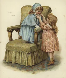 肘掛け椅子のクッションに立っている若い女の子