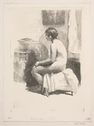 部屋に座っている裸の女性モデル