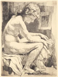 座っている若い裸の女性