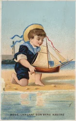 おもちゃの帆船で遊ぶ少年