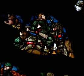 啓示の書からの場面を描いた西のバラの窓：弓と矢と冠を持つ白い馬の男（6：2）。