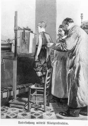 ヴィルヘルム・コンラート・レントゲン（1845-1923）、ハンス・クレーマー著の本から少年をx線撮影する、c.1898-99