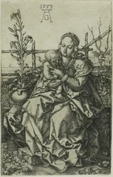 芝生の土手に座る聖母子