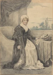 テーブルに座って手紙を持っている女性