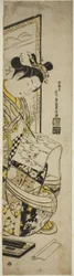 スクリーンの前で手紙を書く女性