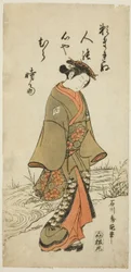 小川の近くを歩く若い女性
