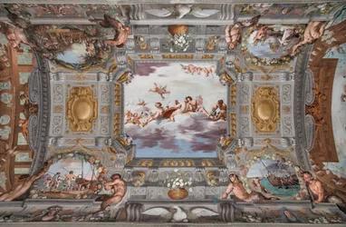 婚礼の宴。雲の上で、バッカス、アリアドネ、ヴィーナスがワインを注ぐ姿とともに円卓に座っている。他の神々は遠くから見守っている。