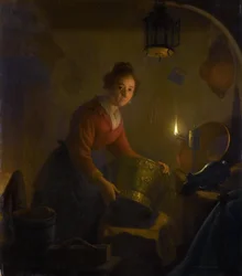 ろうそくの明かりで台所の女性