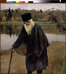 隠者（隠者）。 あごひげと白髪の老人が、杖をついて湖のほとりを歩いています。 Mikhail Vasilyevich Nesterov (1862-1942) の絵画、キャンバスに油彩