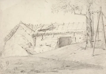 藁の束と杭のついた落葉樹