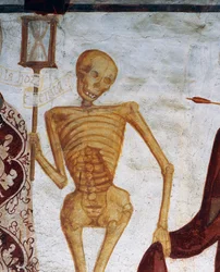 砂時計を掲げる死（『死の舞踏』より）。