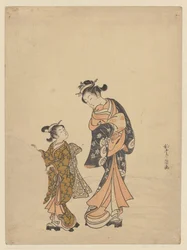 スノーボールの近くの若い女性と女の子