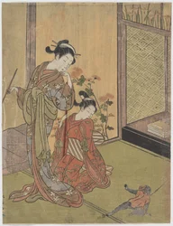 ひもにつながれた猿を見る二人の少女