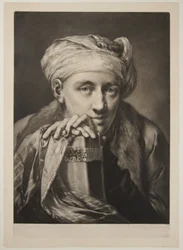 Mann mit Turban, der sich auf ein Buch stützt