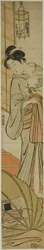蚊帳の下で寝ている息子を見守る母
