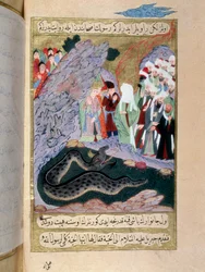 預言者ムハンマド（MohammedまたはMuhammad）（570-632）（顔を覆っている）がミニチュアの蛇を飼いならす様子。18世紀のムハンマドの生涯を語る、エルゼニが書き、セイド・スレイマン・パシャが絵を描いたトルコの写本より。イスタンブール、トルコ・イスラム美術博物館